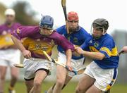 14 March 2004; Barry Lambert of Wexford in action against Diarmuid Fitzgerald, centre, and Michael Phelan of Tipperary during the Allianz Hurling League Division 1B Round 3 match between Wexford and Tipperary at Wexford Park in Wexford. Photo by Pat Murphy/Sportsfile