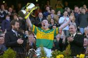 17 March 2004; John McCarthy, Newtownshandrum, lifts the Andy Merrigan cup in the company of GAA President Sean Kelly, left, and Donal Forde, Managing Director, AIB Bank, after victory in the final. AIB All-Ireland Club Hurling Final, Newtownshandrum v Dunloy, Croke Park, Dublin, Picture credit; Brian lawless / SPORTSFILE   *EDI*