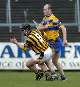 21 March 2004; Paddy Mullally of Kilkenny falls to the ground after he received a punch from Ollie Baker of Clare during the Allianz Hurling League Division 1A Round 4 match between Clare and Kilkenny at Cusack Park in Ennis, Clare. Photo by Ray McManus/Sportsfile