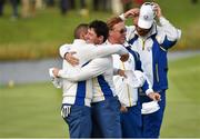 27 September 2014; Rory McIlroy and Sergio Garcia, Team Europe, embrace after winning their match on the 16th green during the afternoon Foursomes Match against Jim Furyk and Hunter Mahan, Team USA. The 2014 Ryder Cup, Day 2. Gleneagles, Scotland. Picture credit: Matt Browne / SPORTSFILE