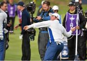 27 September 2014; Rory McIlroy, Team Europe, celebrates winning his match with team-mate Sergio Garcia by throwing a ball into the crowd on the 16th green during the afternoon Foursomes Match against Jim Furyk and Hunter Mahan, Team USA. The 2014 Ryder Cup, Day 2. Gleneagles, Scotland. Picture credit: Matt Browne / SPORTSFILE
