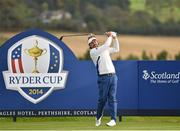 27 September 2014; Victor Dubuisson, Team Europe, watches his tee shot from the 14th during the afternoon Foursomes Match against Jimmy Walker and Rickie Fowler, Team USA. The 2014 Ryder Cup, Day 2. Gleneagles, Scotland. Picture credit: Matt Browne / SPORTSFILE