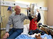 27 September 2014; Kilkenny manager Brian Cody watches Jonah Fanning, age 7, from Wicklow, lift the Liam MacCarthy Cup. Victorious Kilkenny Champions visit Our Lady's Children Hospital. Our Lady's Children Hospital, Crumlin, Co Dublin. Picture credit: Pat Murphy / SPORTSFILE