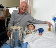 27 September 2014; Kilkenny manaer Brian Cody with Juda Nevin, age 6, from Knocklyon, Co. Dublin. Victorious Kilkenny Champions visit Our Lady's Children Hospital. Our Lady's Children Hospital, Crumlin, Co Dublin. Picture credit: Pat Murphy / SPORTSFILE