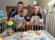 27 September 2014; Kilkenny players Colin Fennelly and Eoin Larkin with Cillian Glynn, aged 7 months, and his brother Liam Glynn, from Mayo. Victorious Kilkenny Champions visit Our Lady's Children Hospital. Our Lady's Children Hospital, Crumlin, Co Dublin. Picture credit: Pat Murphy / SPORTSFILE