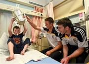27 September 2014; Kilkenny players Colin Fennelly, left, and Michael Rice with nine year old Reece Kelly, age 9, from Shankill, Dublin, and the Liam MacCarthy Cup. Victorious Kilkenny Champions visit Our Lady's Children Hospital. Our Lady's Children Hospital, Crumlin, Co Dublin. Picture credit: Pat Murphy / SPORTSFILE