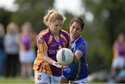 27 September 2014; Lauren Kelly, St. Lawrences, Lancashire, in action against, Andrea Campos Dominguez, Europe. 2014 TESCO HomeGrown All-Ireland Ladies Football Club Sevens Finals. Naomh Mearnóg GAA Club, Portmarnock, Co. Dublin. Picture credit: Barry Cregg / SPORTSFILE