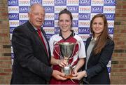 27 September 2014; Orlaith O'Donoghue, St. Brigids, Limerick, receives the Junior Championship cup from Pat Quill, President, Ladies Gaelic Football Association, and  Lynn Moynihan, Local Marketing Manager, Tesco Ireland. 2014 TESCO HomeGrown All-Ireland Ladies Football Club Sevens Finals. Naomh Mearnóg GAA Club, Portmarnock, Co. Dublin. Picture credit: Barry Cregg / SPORTSFILE