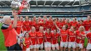28 September 2014; Cork manager Eamon Ryan brings the Brendan Martin Cup to the team after the TG4 All-Ireland Ladies Football Senior Championship Final match between Cork and Dublin at Croke Park in Dublin. Photo by Brendan Moran/Sportsfile