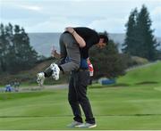 28 September 2014; Rory McIlroy, Team Europe, celebrates with European Tour official Michael Gibbons. The 2014 Ryder Cup, Final Day. Gleneagles, Scotland. Picture credit: Matt Browne / SPORTSFILE