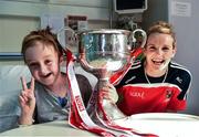 29 September 2014; Cork captain Briege Corkery with eight year old Harry Cooke, from Glasnevin, Co. Dublin, and the Brendan Martin Cup during a visit to Temple Street Childrens Hospital, Dublin. Photo by Sportsfile