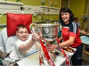 29 September 2014; Cork's Norita Kelly with fifteen year old Jake Naughton, from Rathangan, Co. Wexford, and the Brendan Martin Cup during a visit to Temple Street Childrens Hospital, Dublin. Photo by Sportsfile