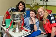 29 September 2014; Cork's Norita Kelly, left, and Vera Foley, with thirteen year old Lauren McCullough, from Dunleer, Co. Louth, and the Brendan Martin Cup during a visit to Temple Street Childrens Hospital, Dublin. Photo by Sportsfile