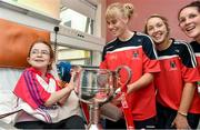 29 September 2014; Cork players Emma Farmer, left, Jenny Barry, and Grace Kearney, right, with Amy Louise Fenton from Middleton, Co. Cork,  and the Brendan Martin Cup during a visit to Temple Street Childrens Hospital, Dublin. Photo by Sportsfile