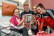 29 September 2014; Cork players Emma Farmer, left, Jenny Barry, and Grace Kearney, right, with Amy Louise Fenton from Middleton, Co. Cork,  and the Brendan Martin Cup during a visit to Temple Street Childrens Hospital, Dublin. Photo by Sportsfile