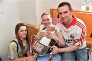 29 September 2014; Cork Eimear Scally with seventeen week old Lorcan O'Halloran from Charleville, Co. Cork, his parents John and Marie O'Halloran and the Brendan Martin Cup during a visit to Temple Street Childrens Hospital, Dublin. Photo by Sportsfile
