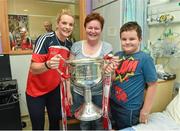 29 September 2014; Cork captain Briege Corkery with nine year old Jamie O'Boyle from Sligo and his mother Mary and the Brendan Martin Cup during a visit to Temple Street Childrens Hospital, Dublin. Photo by Sportsfile