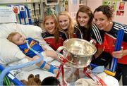 29 September 2014; Cork players, from left, Mairead Corkery, Vera Foley, Marie Ambrose, and Geraldine O'Flynn, and two year old Billy Goulding from Birr, Co. Offaly and the Brendan Martin Cup during a visit to Temple Street Childrens Hospital, Dublin. Photo by Sportsfile