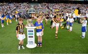 27 September 2014; Roísín O'Meara, Narnane NS, Tipperary, and Alex Cass, Thomastown NS, Kilkenny, carry the Liam MacCarthy cup onto the pitch ahead of the game as Kilkenny's JJ Delaney runs out. GAA Hurling All Ireland Senior Championship Final Replay, Kilkenny v Tipperary. Croke Park, Dublin. Picture credit: Stephen McCarthy / SPORTSFILE