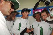22 March 2007; Ireland's, from left, Coach Darian Birrell, David Langford-Smith and Andrew White as team captain Trent Johnston receives a phone call on behalf of the team from President of Ireland Mary McAleese. Sabina Park, Kingston, Jamaica Picture credit: Pat Murphy / SPORTSFILE