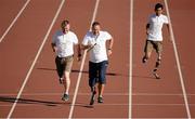 4 October 2014; Pictured are, from left to right, Sean Baldwin, Ted Smithers and Pawan Sitthisung in action during the relay race at the first ever running blades workshop held in Ireland hosted by Paralympics Ireland in partnership with sponsors Mondelez, and blade manufacturer Ottobock. The unique event saw eight individuals who had been prefitted for the technology given the opportunity to experience and showcase the blades with almost a fifty additional prosthesis users and amputees taking part in activity session to promote Paralympic sport. Morton Stadium, Santry, Dublin. Picture credit: Barry Cregg / SPORTSFILE