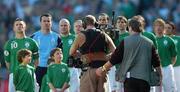 24 March 2007; The Republic of Ireland team, from left, captain Robbie Keane, Shay Given, Lee Carsley, Damien Duff, John O'Shea, Kevin Kilbane, Richard Dunne, hidden, Paul McShane, and Jonathan Douglas, stand with mascots for the National Anthem, as they are watched by a TV cameraman. 2008 European Championship Qualifier, Republic of Ireland v Wales, Croke Park, Dublin. Picture credit: Brian Lawless / SPORTSFILE