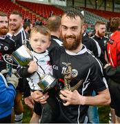 5 October 2014; Conor Laverty, Kilcoo Eoghain Rua, celebrates his man of the match award with his two year old Setanta Laverty. Down County Senior Football Championship Final, St Marys v Kilcoo Eoghain Rua. Páirc Esler, Newry. Picture credit: Oliver McVeigh / SPORTSFILE