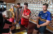 6 October 2014; Silversmith Kevin Williams cleans the  European Rugby Champions Cup as Munster's Peter O'Mahony, left, and Leinster's Jamie Heaslip watch on at the launch of the European Rugby Champions Cup and European Rugby Challenge Cup. Convention Centre Dublin, Spencer Dock, North Wall Quay, Dublin. Picture credit: Stephen McCarthy / SPORTSFILE