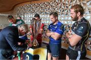 6 October 2014; Silversmith Kevin Williams cleans the  European Rugby Champions Cup as Antonio Pavanello, Treviso, left, Leinster's Jamie Heaslip and Ospreys Alun-Wyn Jones, right, watch on at the launch of the European Rugby Champions Cup and European Rugby Challenge Cup. Convention Centre Dublin, Spencer Dock, North Wall Quay, Dublin. Picture credit: Stephen McCarthy / SPORTSFILE