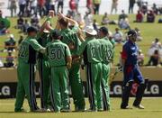 30 March 2007; Boyd Rankin, Ireland, 20, celebrates with his team-mates as England's Ed Joyce makes his way back to the pavilion. ICC Cricket World Cup 2007, Super 8, Ireland v England, Guyana National Stadium, Georgetown, Guyana. Picture credit: Pat Murphy / SPORTSFILE