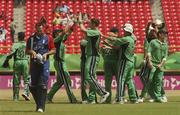 30 March 2007; Michael Vaughan, England, makes his way to the pavillion while the Ireland players celebrate. ICC Cricket World Cup 2007, Super 8, Ireland v England, Guyana National Stadium, Georgetown, Guyana. Picture credit: Pat Murphy / SPORTSFILE