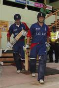 30 March 2007; England batsmen Ed Joyce and Michael Vaughan, left, make their way to the pitch while Ireland's Kenny Carroll looks on. ICC Cricket World Cup 2007, Super 8, Ireland v England, Guyana National Stadium, Georgetown, Guyana. Picture credit: Pat Murphy / SPORTSFILE