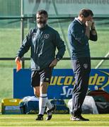 10 October 2014; Republic of Ireland assistant manager Roy Keane walks past manager Martin O'Neill during squad training ahead of their UEFA EURO 2016 Championship Qualifer, Group D, game against Gibraltar on Saturday. Republic of Ireland Squad Training, Gannon Park, Malahide, Co. Dublin. Picture credit: David Maher / SPORTSFILE