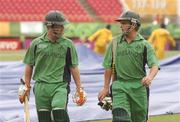 3 April 2007; Ireland's Eoin Morgan, left, and William Porterfield leave the pitch as the rain covers are brought on by the ground staff. ICC Cricket World Cup 2007, Super 8, Ireland v South Africa, Guyana National Cricket Stadium, Georgetown, Guyana. Picture credit: Pat Murphy / SPORTSFILE