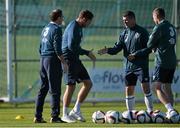 12 October 2014; Republic of Ireland's Richard Keogh, shakes hands with  Republic of Ireland assistant manager Roy keane, alongside manager Martin O'Neill and coach Steve Guppy, before departing the squad due to injury, during squad training ahead of their UEFA EURO 2016 Championship Qualifer, Group D, game against Germany on Tuesday. Republic of Ireland Squad Training, Gannon Park, Malahide, Co. Dublin. Picture credit: David Maher / SPORTSFILE