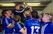 12 October 2014; Cratloe manager Colm Collins is held aloft in the dressing room by his players after victory over Eire Og. Clare County Senior Football Championship Final, Cratloe v Eire Og. Cusack Park, Ennis, Co. Clare. Picture credit: Diarmuid Greene / SPORTSFILE