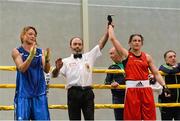 12 October 2014; Katie Taylor's hand is raised by the match referee after her victory against Oshin Derieuw. International Boxing, Katie Taylor v Oshin Derieuw, University of Limerick, Limerick. Picture credit: Diarmuid Greene / SPORTSFILE