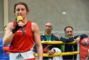 12 October 2014; Coaches Pete Taylor and Zuar Anita look on as Katie Taylor speaks to the crowd after her bout with Oshin Derieuw. International Boxing, Katie Taylor v Oshin Derieuw. University of Limerick Arena, Limerick. Picture credit: Diarmuid Greene / SPORTSFILE