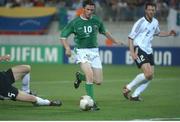 5 June 2002; Robbie Keane, Republic of Ireland, slips past Carsten Ramelow on his way to score against Germany. FIFA World Cup Finals, Group E, Republic of Ireland v Germany, Ibaraki Stadium, Ibaraki, Japan. Picture credit: David Maher / SPORTSFILE