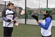 17 October 2014; Clare Hurler Shane O Donnell showcasing his hurling skills to delegate Liliana Fernandez, from Venezuela, from the One Young World Summit at Na Fianna GAA club, Glasnevin, Dublin. Picture credit: David Maher / SPORTSFILE
