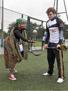 17 October 2014; Clare Hurler Shane O Donnell showcasing his hurling skills to delegate Remofilwe Lechalaba, from South Africa, from the One Young World Summit at Na Fianna GAA club, Glasnevin, Dublin. Picture credit: David Maher / SPORTSFILE