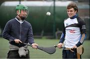 17 October 2014; Clare Hurler Shane O Donnell showcasing his hurling skills to delegate Daisure Ishii, from Japan, from the One Young World Summit at Na Fianna GAA club, Glasnevin, Dublin. Picture credit: David Maher / SPORTSFILE