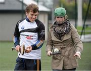 17 October 2014; Clare Hurler Shane O Donnell showcasing his hurling skills to delegate Katie Vojir, from Pennsylvania, USA, from the One Young World Summit at Na Fianna GAA club, Glasnevin, Dublin. Picture credit: David Maher / SPORTSFILE