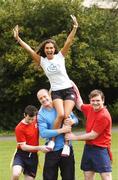 10 April 2007; Leinster and Ireland winger Denis Hickie holds model Roberta Rowat aloft with the help of Sean O'Connell, left, and Ian Darcy of the Beauties and the Beasts Tag Rugby Team at the launch of the Volvic Tag Rugby Summer Leagues. Herbert Park, Ballsbridge, Dublin. Photo by Sportsfile