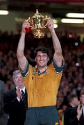 6 November 1999; Australia captain John Eales lifts the Webb Ellis Cup following the Rugby World Cup Final match between Australia and France at the Millenium Stadium in Cardiff, Wales. Photo by Brendan Moran/Sportsfile