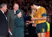 6 November 1999; Australia captain John Eales receives the Webb Ellis Cup from HRH Queen Elizabeth following the Rugby World Cup Final match between Australia and France at the Millenium Stadium in Cardiff, Wales. Photo by Brendan Moran/Sportsfile