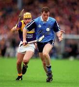 30 May 1999; Liam Walsh of Dublin in action against Adrian Fenlon of Wexford during the Guinness Leinster Senior Hurling Championship Quarter-Final match between Dublin and Wexford at Nowlan Park in Kilkenny. Photo by Ray Lohan/Sportsfile