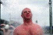 28 August 1999; John Ward showers after winning the Liffey Swim in Dublin. Photo by Aoife Rice/Sportsfile