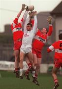 14 November 1999; Ronan Sweeney of Kildare in action against Dermot Heaney, left, and Michael McIvoe of Derry during the Church & General National Football League match between Kildare and Derry at St Conleth's Park in Newbridge, Kildare. Photo by Damien Eagers/Sportsfile