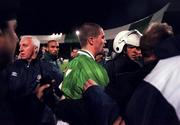 17 November 1999; Roy Keane of Republic of Ireland is escorted from the pitch following during the UEFA European Championships Qualifier Play-Off Second Leg match between Turkey and Republic of Ireland at the Ataturk Stadium in Bursa, Turkey. Photo by Brendan Moran/Sportsfile